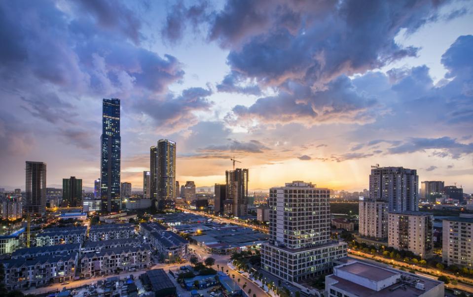 gray high-rise buildings under gray clouds during golden hour